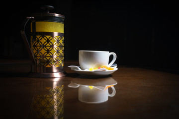 Tea on a black background. Fruit tea. Cold tea. Teapot with tea.