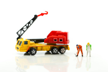 Miniature people : worker team for building home ,Image use for construction, business or Building and Code Staff Appreciation Day concept,house repair or home renovating