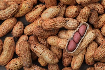 Peanuts in shell texture background. Raw peanuts on display at a farmer's market top view above flat lay