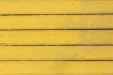 Yellow colored wood background. Wooden scratched abstract background.