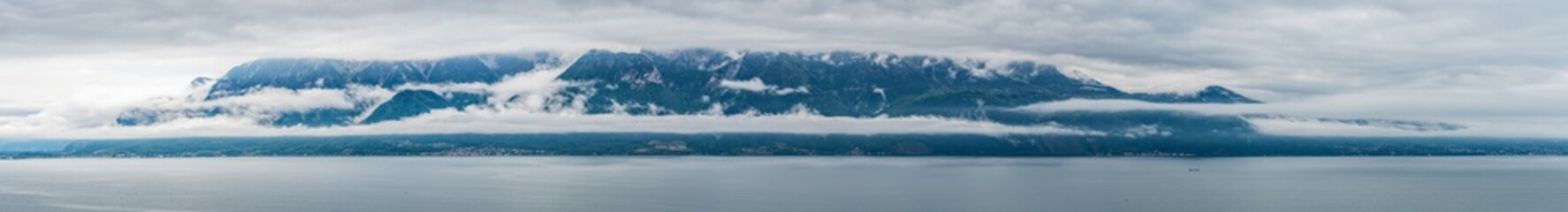 Fototapeta na wymiar Switzerland, scenic view on Alps with fog, clouds near lake Leman