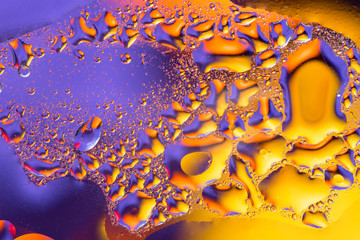 Colorful abstract background. Water drops rainbow colors on glass. Amazing abstract water drops on glass texture or background.