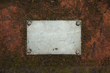 Metal gray empty plate with scratches on a rusty steel surface