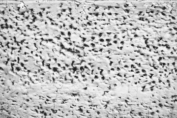 Detailed imperfect white texture of aerated foam block with holes close-up. Side of building is painted whitish. Background of construction from foamed material in macro. Decorative facing of house.