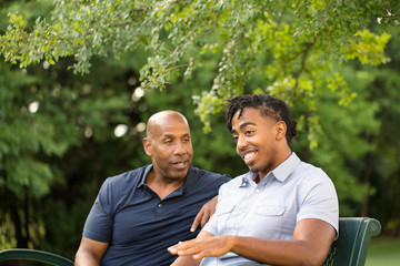 African American father and his adult son.