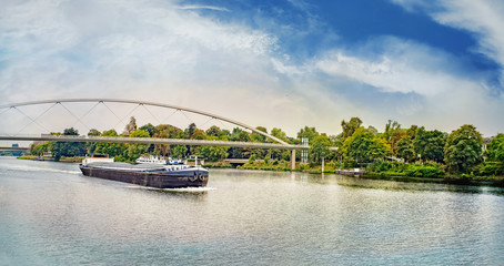 Fototapeta premium Barge under the Hoger Brug (Higher Bridge) on the River Maas
