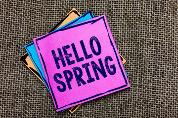 Handwriting text Hello Spring. Concept meaning Welcoming the season after the winter Blossoming of flowers Paper notes Important reminders Communicate ideas messages Jute background