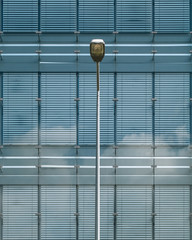 Obraz premium Facade blue office building and a treet lamp