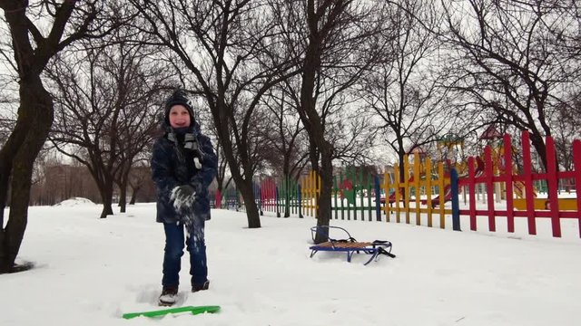 HD Cheerful boy is playing in the snow