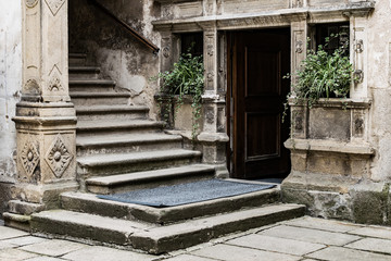 Fototapeta na wymiar ancient gothic door passage from stone stairs