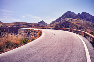 Vintage stylized picture of a mountain road bend, Mallorca, Spain.