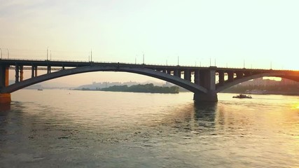 Low drone flight under the communal bridge over the Yenisei river