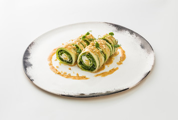 Sushi roll with cheese Philadelphia and salmon on a plate isolated on white background