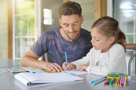 Daddy with little girl doing homework