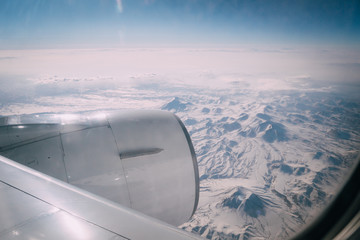 Naklejka na ściany i meble view of mountains from airplane window
