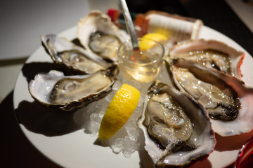 Tasty fresh oysters close-up on ice. Raw oysters are packed with nutrition, high in calcium, potassium, magnesium, vitamin and mineral. Flavor are sweet and refreshing. Believed to be an aphrodisiac.