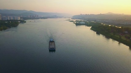 Beautiful aerial drone shot of a big ship sails along the Yenisei river