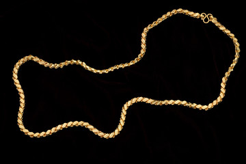 Golden chain on a dark pattern