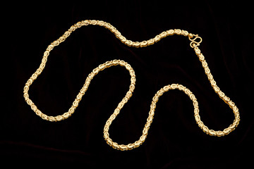 Golden chain on a dark pattern