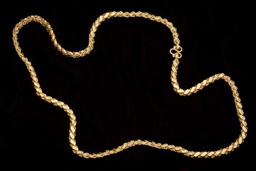 Golden chain on a dark pattern