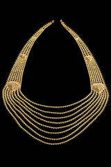 Golden paendant on a dark pattern