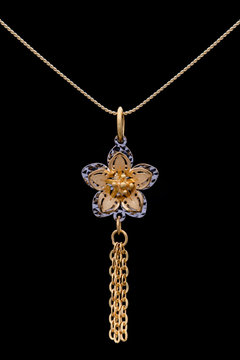 Modern golden pendant on a dark pattern
