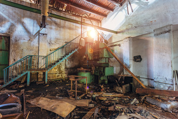 Fototapeta na wymiar Old industrial machine tools in workshop. Rusty metal equipment in abandoned factory