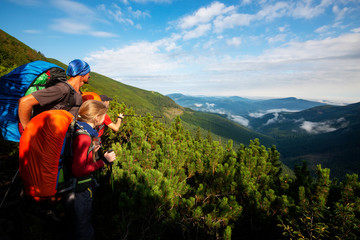 Hikers -  father and teenage daughter with backpacks