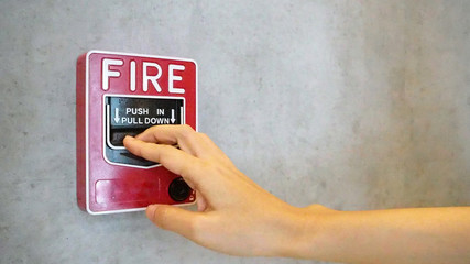 Fire alarm notifier or alert or bell warning equipment use when on fire with hand.