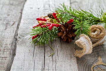 Pine cones and branch on rustic wood background