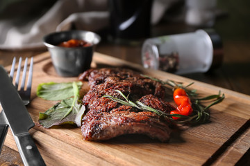 Delicious grilled steak on wooden board