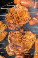 Unhealthy but tasty grilled sausages and meat