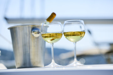 Pair of wineglasses against the yacht