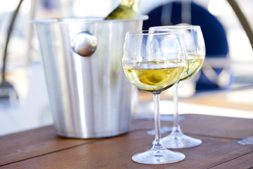 Pair of wineglasses against the yacht