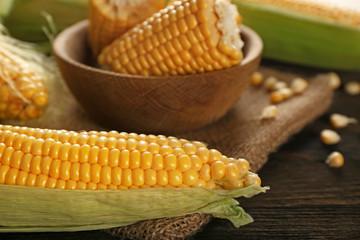 Fresh corn cob on wooden table, closeup