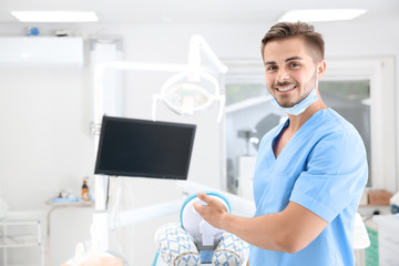 Young male dentist in clinic