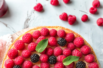 Delicious cheesecake with raspberries on table, closeup
