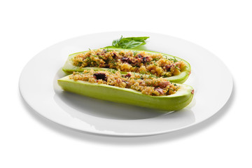 Plate with quinoa stuffed zucchini boats on white background