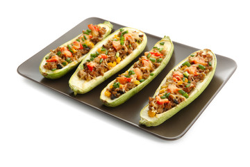 Plate with meat stuffed zucchini boats on white background