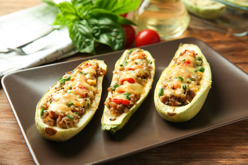 Meat stuffed zucchini boats on plate, closeup
