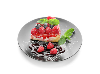 Plate with piece of delicious raspberry cheesecake on white background