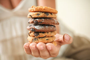 Woman holding delicious cookies, closeup