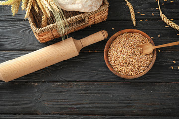 Composition with wheat grains on wooden background