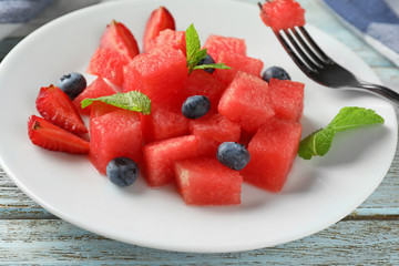 Sweet watermelon slices and blueberries on plate, closeup