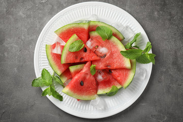 Plate with sweet watermelon slices on table