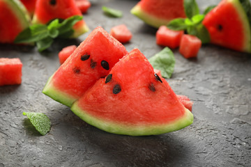 Sweet watermelon slices on grey table