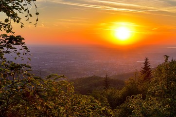 Beautiful mountain landscape. Sunset over the hills and cities.