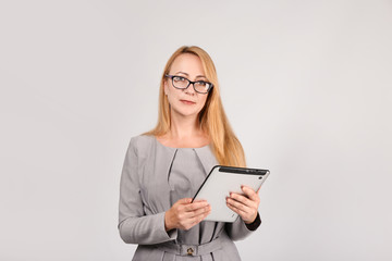Stylish businesswoman with clipboard on grey background