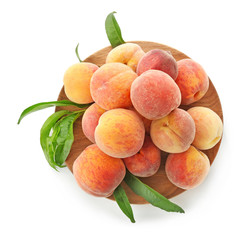 Plate with fresh peaches on white background