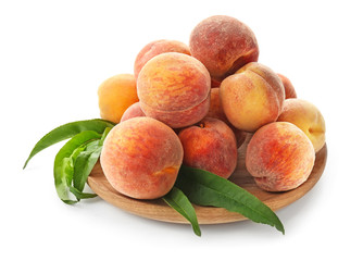 Plate with fresh peaches on white background